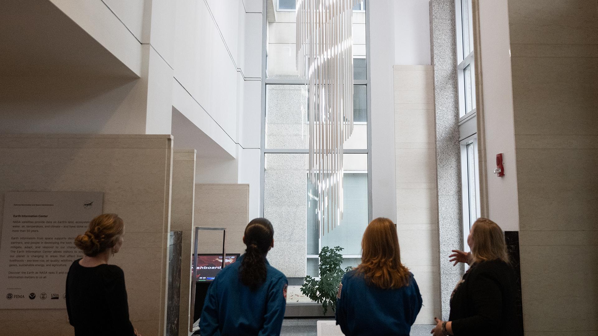 Expedition 70 Crew with Earth Pulse display at NASA Headquarters in November 2024.