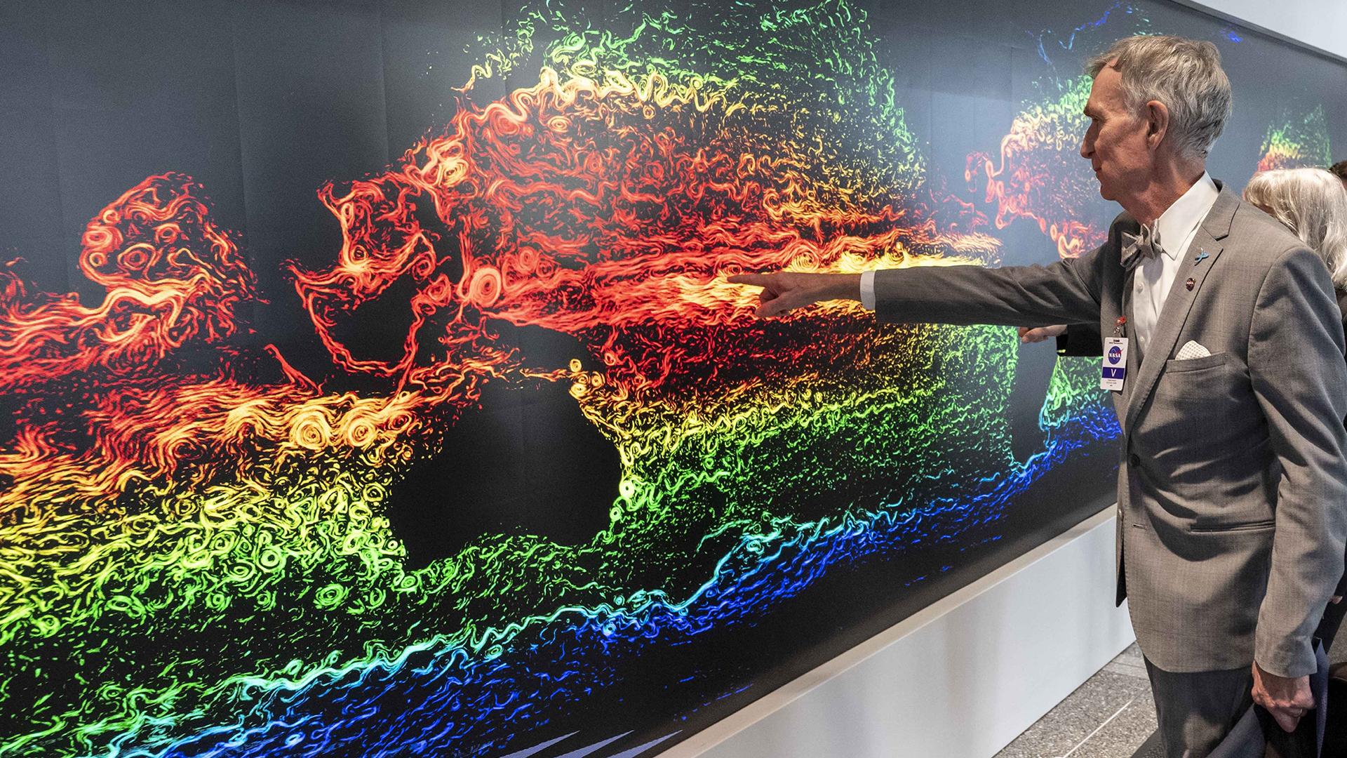 Bill Nye interacting with The Earth Information Center's Hyperwall at NASA Headquarters.